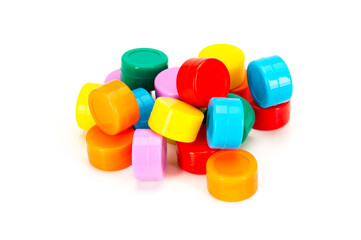 A pile of bright, colorful plastic storage caps arranged on a clean white background. Vibrant reusable containers used for crafts, organization, and household storage.