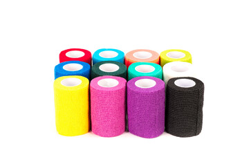 A variety of colorful cohesive bandage rolls neatly arranged on a clean white background. Ideal for medical, sports, veterinary, first aid, and healthcare product themes.