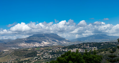 View from heights of Erice to scenic coastal roads, olive groves, panoramic view on Riserva Naturale Orientata Monte Cofano and Mediterranean sea, travel destination in Italy