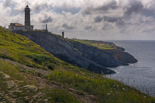 Scenic view of rocky Atlantic coast of cape Mayor with lighthouse in sunny summer day, Santander, Spain.