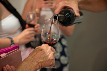 Tasting of Banyuls AOC aged natural sweet grand cru Banyuls fortified dessert wine from old vines from slopes Pyrenees in Roussillon, France made in glass jar Dame Jeanne or demijohn