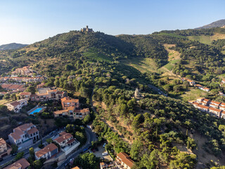 Obraz premium Aerial view of colourful Collioure, narrow streets and yellow, pink, orange houses, summer vacation destination town with historical buidings, beaches, Pyrenees-Orientales, France