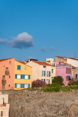 Fototapeta premium View of colourful Collioure, narrow streets and yellow, pink, orange houses, summer vacation destination town with historical buidings and beaches, Pyrenees-Orientales, France