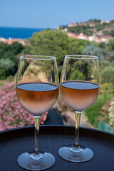 Summer vacation on Mediterranean sea, drinking cold rose wine in glass in sunlights, Collioure, Occitanie, South of France, tourists destination