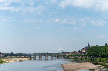 View on cooling towers of nuclear power plant thermal power station in which heat source is nuclear reactor, France, Europe, cheap energy source, Gien on Loire river