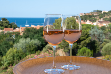 Summer vacation on Mediterranean sea, drinking cold rose wine in glass in sunlights, Collioure, Occitanie, South of France, tourists destination