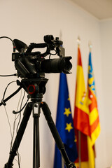 Video camera recording a press conference