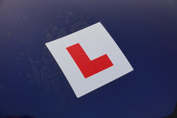 L plate on car of new driver. Learner badge of recently passed test