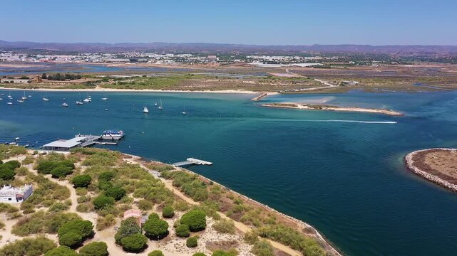 Aerial view drone shot of Tavira Portugal Algarve aerial view of ria formosa estuary with turquoise water, boats and marsh islands drone survey of wetlands, calm reflection, lush reeds,