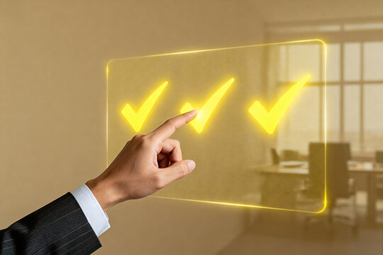 Hand touching a digital screen with three glowing checkmarks in a modern office setting