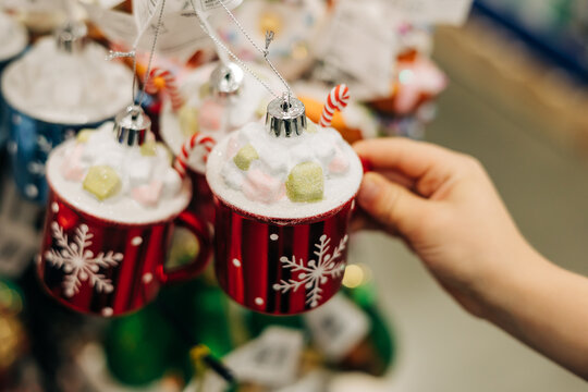 Festive holiday mugs with sweet decorations in a store during the winter season - Powered by Adobe
