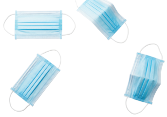 Four light blue disposable medical surgical face masks with white elastic ear loops, flat lay on a transparent background, soft studio light, copy space for proactive health and safety concept