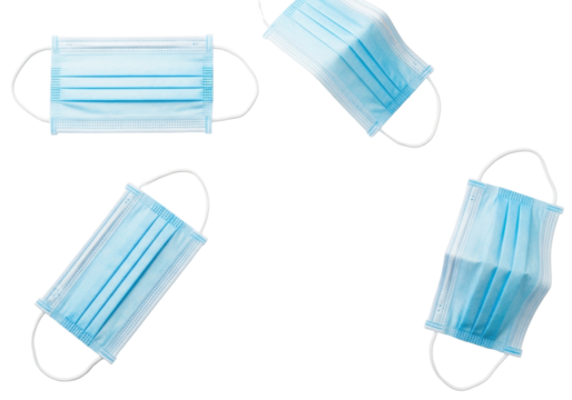 Four light blue disposable medical surgical face masks with white elastic ear loops, flat lay on a transparent background, soft studio light, copy space for proactive health and safety concept