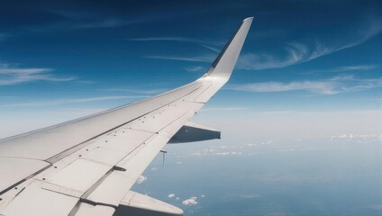 Obraz premium Airplane Wing View Above the Clouds on a Sunny Day.