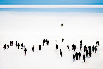 The salt lake in Ankara, Turkey fascinates visitors with its white salt cover. The photo shows many visitors walking on the salt lake.