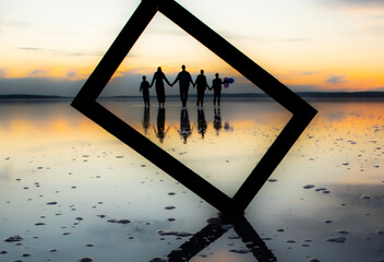 Tuz Lake, located in Ankara province of T&uuml;rkiye, has a wonderful view at sunset. Visitors walking in the shallow waters of the lake watch the sunset by taking photos or taking pictures.