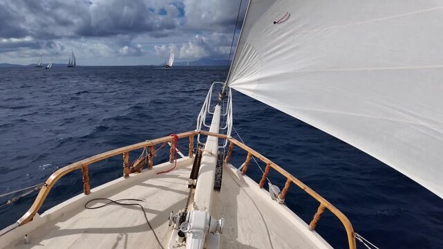 	
Bow Of Sailing Boat Navigating In The Sea. the front of the boat and the sail	
