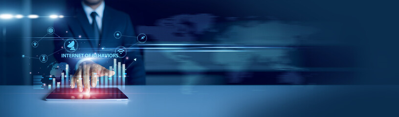 Businessman using tablet analyzing Internet of Behaviors and growth graph chart, consumer data...