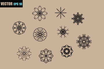 Collection of intricate black and white geometric snowflake and floral ornamental designs arranged on a neutral background for decorative purposes