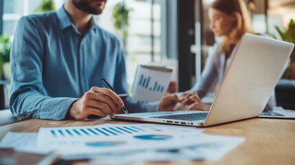 Business people discussing and analyzing financial data in an office