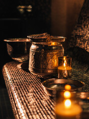 Hammam and sauna accessories with copper bucket and candles in romantic atmosphere