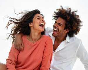 Man and woman laughing and smiling together, with joyful facial expressions and relaxed body language, conveying happiness and togetherness.