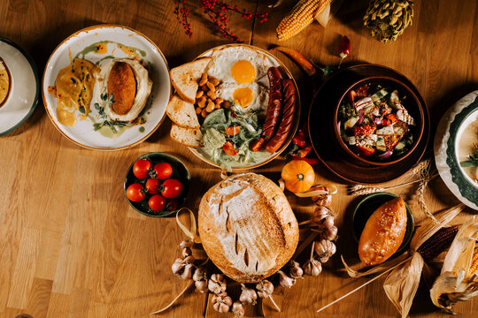 Delicious spread of traditional breakfast dishes on a rustic wooden table