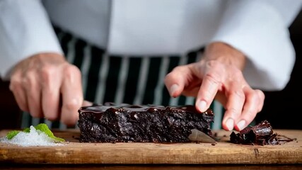 Chef slicing rich chocolate cake, decadent dessert preparation, gourmet culinary artistry for special occasions