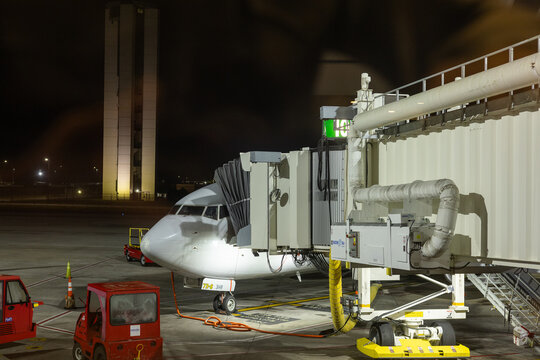 SAVANNAH, GEORGIA, USA, NOVEMBER 9, 2025: A regional passenger jet, connected to a jet bridge for boarding, is parked on the ramp at Savannah/Hilton Head International Airport (SAV), with the airport'