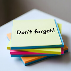 Important reminder 'don't forget!' on colorful sticky notes stack