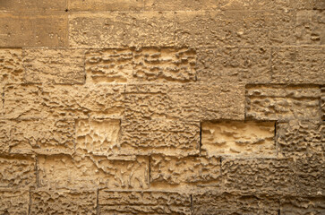 Old stone wall with limestone erosion closeup in Lecce, Italy