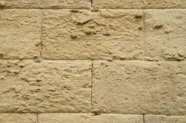Old stone wall with limestone erosion close up in Lecce, Italy