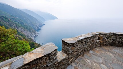 Scenic rocky coastal view of cliffside and ocean on cloudy day