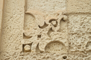 Baroque Weathered Stone carved ornament on facade of building in Lecce, Italy