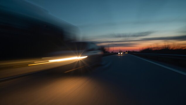 Abstract Roadscape. Streaks of Light and Motion Under a Twilight Sky, Evening Drive.