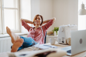 Female fashion designer starting her own small sewing business.