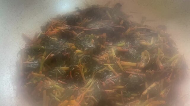 Cooking of red spinach or amaranth locally known as laal saag. 