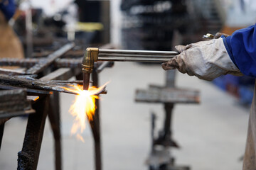 Artisan worker cutting metal with oxy-acetylene torch
