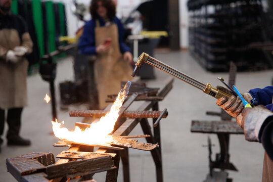 Artisan worker welding metal with cutting torch - Powered by Adobe