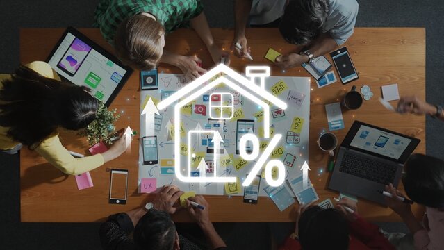 A diverse team engages in a collaborative brainstorming session at a modern workspace, focusing on home improvement strategies and user experience analytics. Raster
