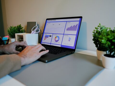 Middle Aged Male Business Analyst Sorting Through Graphs and Charts Preparing for Executive Presentation - Business Analysis Concept - Powered by Adobe