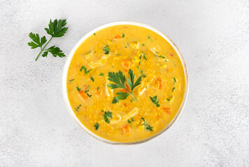 Traditional Indian Mulligatawny soup with vegetables, lentils, spices on white background. Top view.