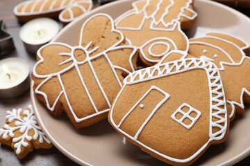 Tasty gingerbread cookies and burning candles on table, closeup. Christmas treat