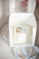 Birthday cake in box, 2 years old cake, ukrainian text. cream cake with bear decor, balls on the cake, sweets