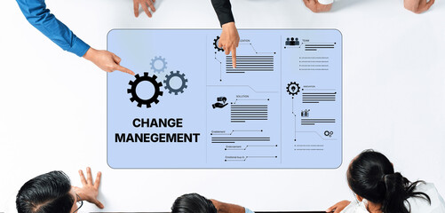 Multi-person team collaborates on change management strategies, using visual aids to enhance communication and efficiency in corporate settings. Ideal for business projects. Trope