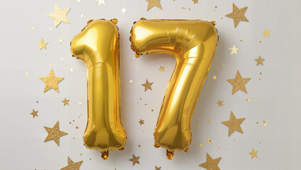 Obraz premium Number 17 golden balloons on white background with star confetti