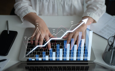 Focused hands typing on a laptop with overlaying graphs, showcasing data analysis and growth trends in a modern office setting, emphasizing productivity and technology. Scalp
