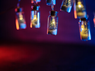 Christmas garland with snow and fir trees in small glass jars. Copy space