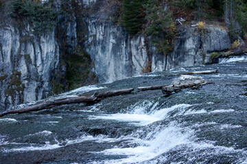 Towering cliffs frame a torrent of water as it plunges into the rugged Idaho canyon.