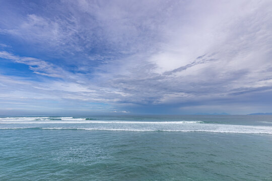 The ocean is calm and the sky is cloudy